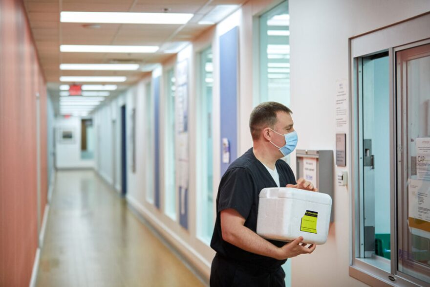 Philip Mudd picks up a cooler of medical samples at Washington University's School of Medicine. Mudd and his colleague Jane O'Halloran created a centralized bank of samples collected from COVID-19 patients in St. Louis.