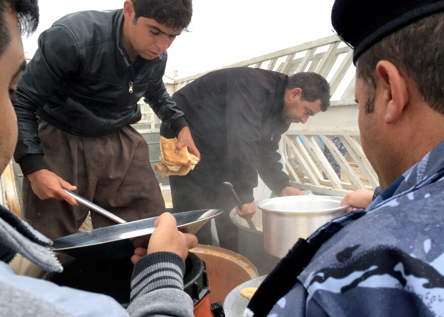 SWAT members, shown here at mealtime, live in tents with dirt floors and train without weapons.