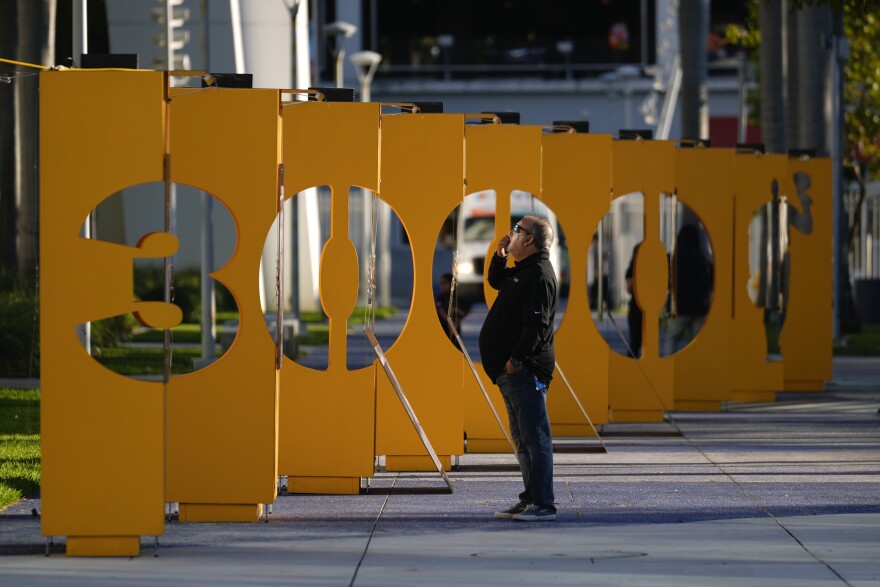 A man looks at a traveling exhibit of images from Roberto Clemente's Major League Baseball career, titled 3000 in a nod to his 3000 career hits, during its installation at Miami Marlins' loanDepot Park in Miami, Wednesday, Jan. 31, 2024.