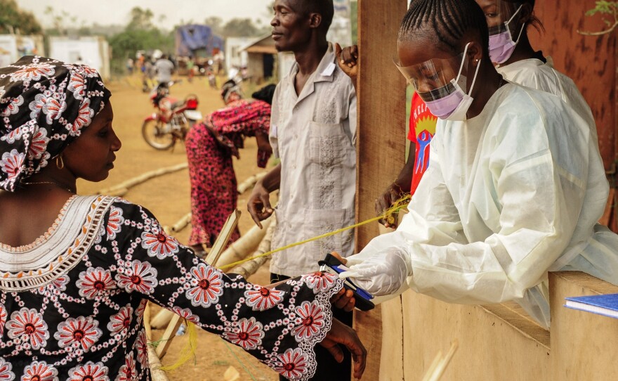 Sierra Leone health officials check people passing through the border with Liberia in Jendema last month. For the past two weeks, Sierra Leone has recorded only nine cases.