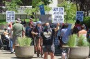 People protesting outside building. 