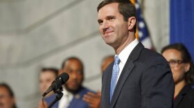 FILE- In this Dec. 12, 2019 file photo, Kentucky Gov. Andy Beshear speaks at a press conference before signing an executive order to reinstate the voting rights of over 100,000 non-violent felons who have completed their sentences, at the Capitol in Frankfort, Ky. Beshear is calling for bipartisan cooperation during a legislative session that will be dominated by work on a new two-year state budget. (AP Photo/Bryan Woolston, File)
