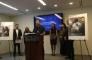 Harvard data scientist Kyle Frankovich stands at a Sept. 17, 2026, news conference between photos of Department of Homeland Security social media posts using images of him with his arms zip-tied behind his back after protesting at the Broadview immigration detention center.