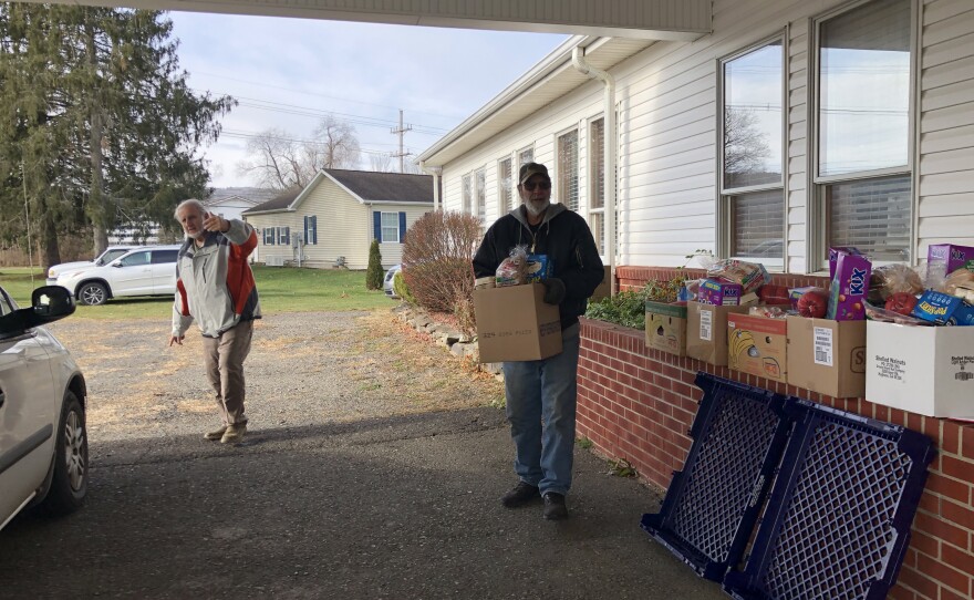 CHOP volunteer, Jim Crown directs a car through the Pop Up Pantry.