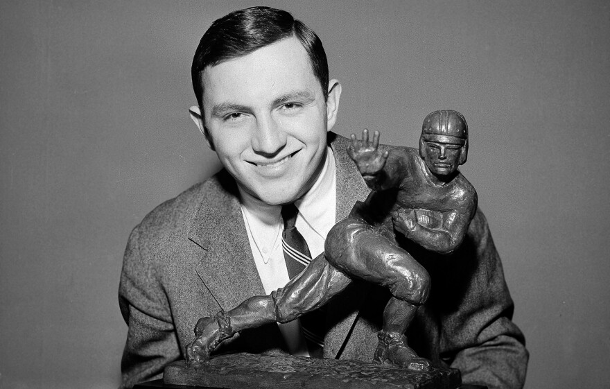 Dick Kazmaier of Princeton University poses with the Heisman Trophy at New York's Downtown Athletic Club before the official presentation in 1951. Kazmaier, the last Ivy Leaguer to win the Heisman Trophy, died on Thursday.