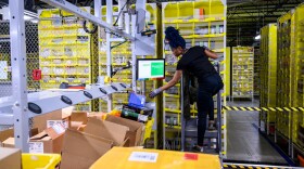 A woman works at a distribution station an Amazon fulfillment center. (Johannes Eisele/AFP via Getty Images)