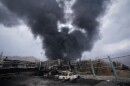 A thick plume of smoke rises from an oil storage facility hit by a U.S.-Israeli strike in Tehran, Iran, March 8, 2026.