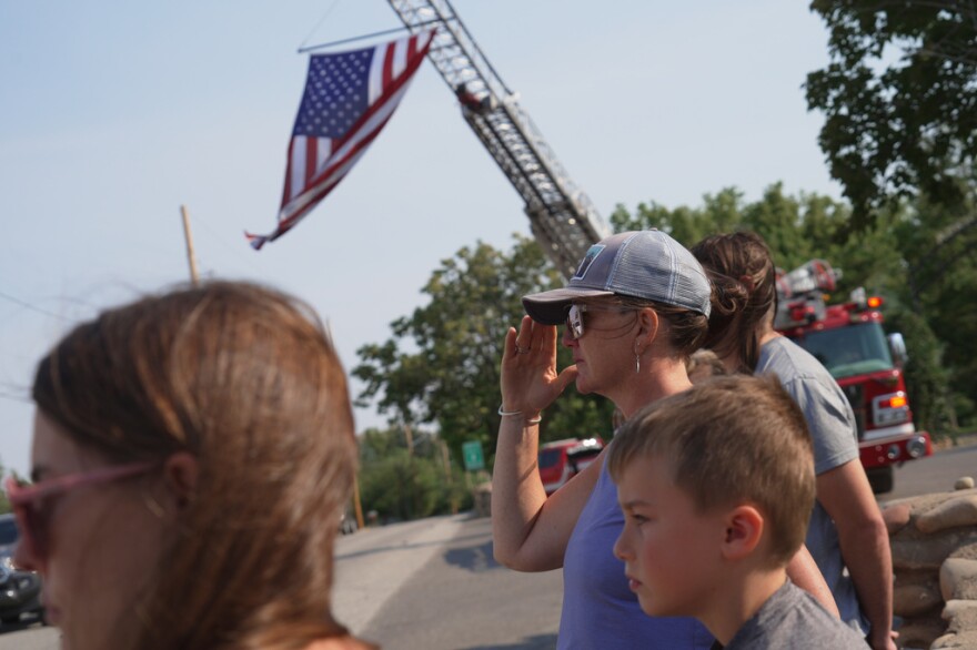 People salute a flag during a procession