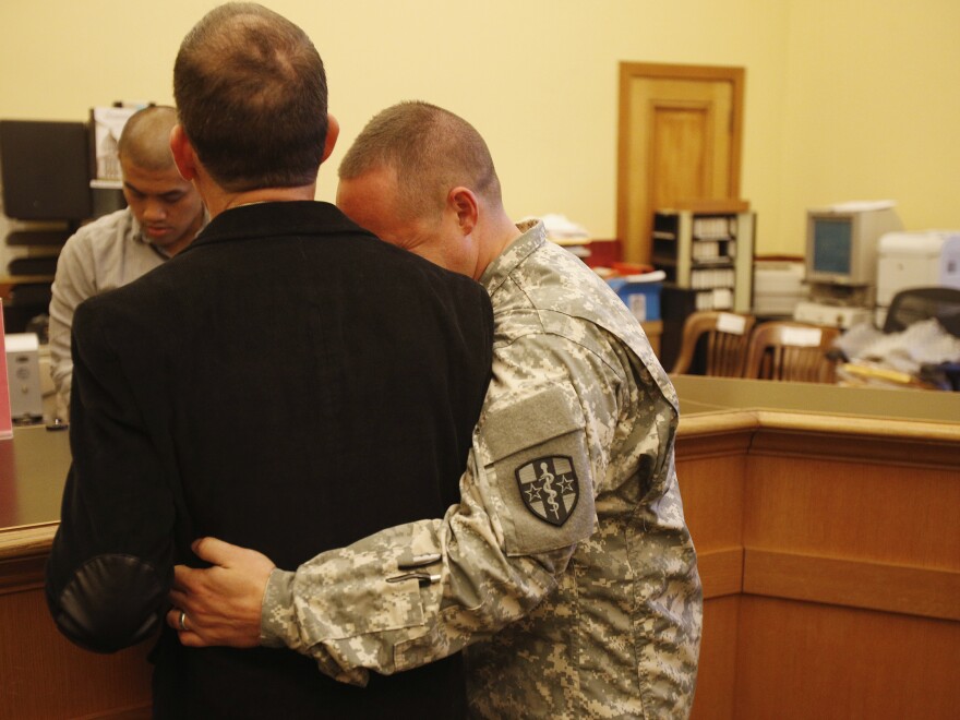 U.S. Army Captain Michael Potoczniak (right) embraced his partner of 10 years Todd Saunders as they obtained their marriage license at City Hall in San Francisco on June 29.