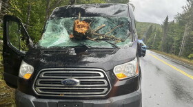 This image provided by Maine State Police shows the vehicle of an Ohio driver who suffered minor injuries Saturday, Sept. 16 2023 after tree downed by the remnants of tropical storm Lee went through his windshield on Route 11 in Moro Plantation, Maine, according to Maine State Police. John Yoder, 23, of Apple Creek, Ohio attempted to stop but couldn’t avoid the tree. Yoder suffered minor cuts but the other five passengers in the van were not injured. Police blamed high winds for the downed tree.