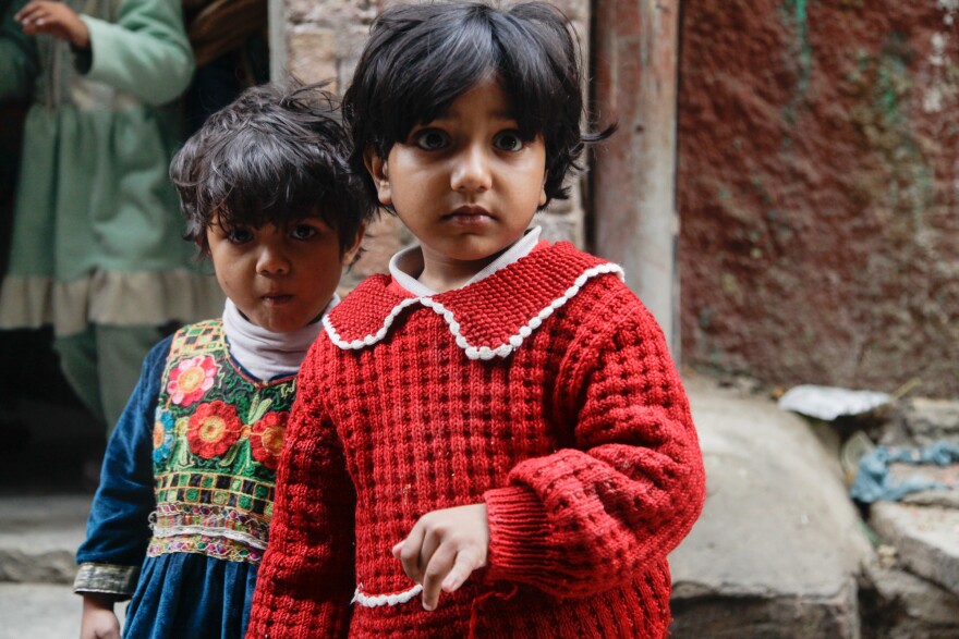 A child sticks out her pinkie finger to show she's been vaccinated. Health workers mark vaccinated children with a sharpie on the pinkie — it only fades after a week or so — to help identify children who've missed out on the oral polio vaccine dose.