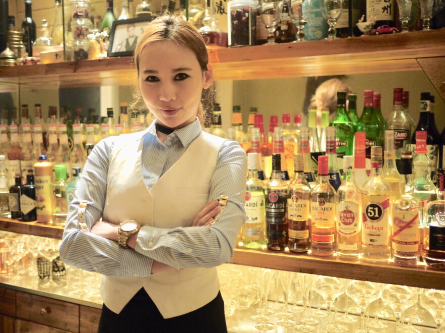 Moe stands behind her tiny bar in Shanghai, where there are only eight seats and reservations are a must.