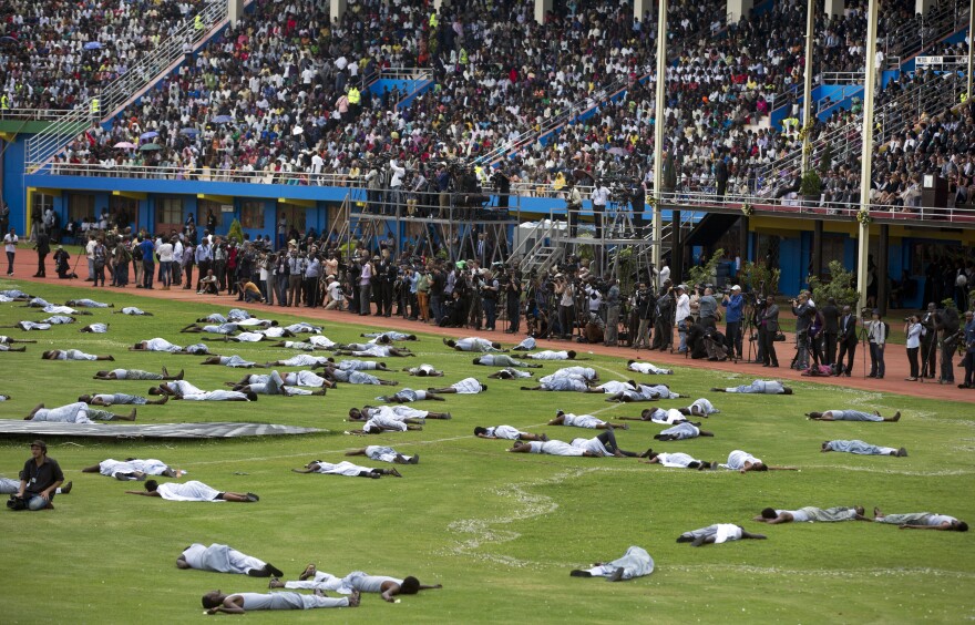 Performers re-enact the events of the genocide at Amahoro stadium on Monday. Ethnic tension between the majority Hutus and minority Tutsis erupted in 100 days of brutality.