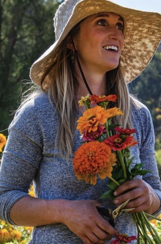 Harper Kaufman, with flowers, at Two Rivers Farm. The community supported agriculture facility sits on Pitkin County Open Space and Trails Land in Emma, CO.