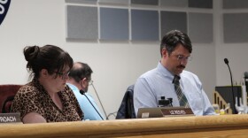 Fairbanks North Star Borough Assembly members Liz Reeves, left, and Scott Crass, right, listen to public testimony about renaming Pioneer Park during a meeting that began April 23, 2026, which ran into the following day. Reeves and Crass cosponsored an ordinance to revive the park's former name, "Alaskaland." It passed April 24, 2026.