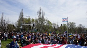 Demonstrators display a large American flag during a No Kings protest in opposition to the Trump administration in Flagstaff, March 28, 2026.