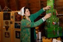 Artist and co-organizer Sarah Fleming hangs an ornament on her display at the Shuckin' Awesome Holiday Art Market at Funk Farms Premium Beef.