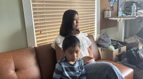 Wendy Domingo, 18, sits on a couch at the Guatemalan-Maya Center in Lake Worth Beach alongside her little brother. She is now the adult in charge of her four siblings after Border Patrol agents pulled over and detained both her parents in front of them all.