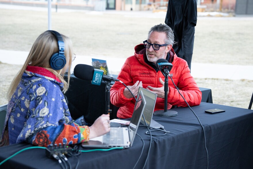 Aspen One Senior Vice President of Sustainability Chris Miller (right) speaks to Aspen Public Radio’s Sage Smiley during a special live broadcast outside the Pitkin County Library on March 4, 2026.