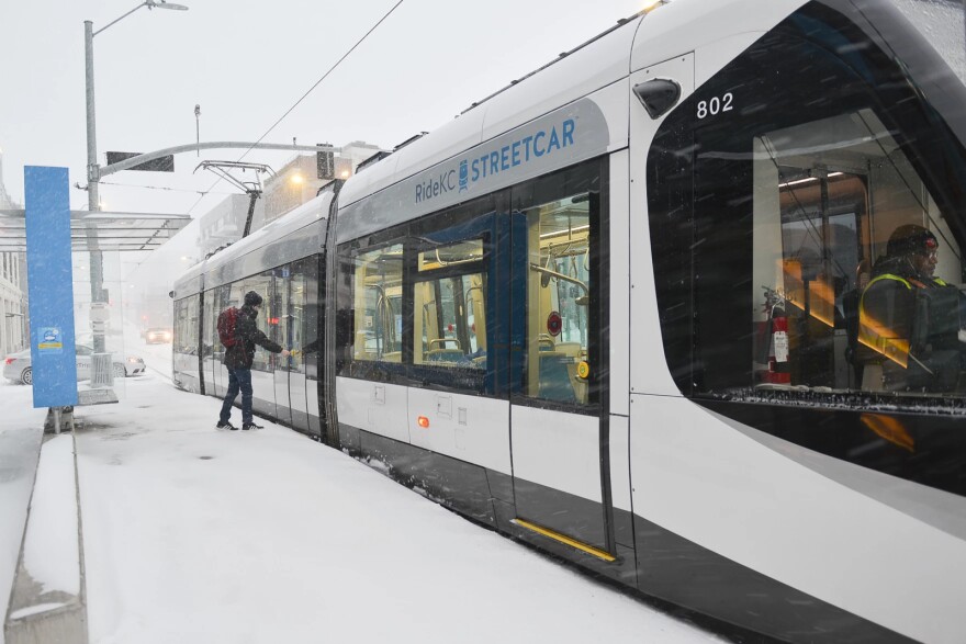 A rider enters a KC Streecar early Wednesday morning near 17th and Main Street.
