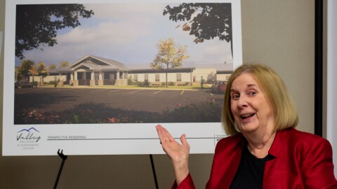 Kimberly McClanahan, executive director of the Valley Community Services Board, displays an artistic rendering of the Valley Recovery and Assessment Center being built in Fishersville.