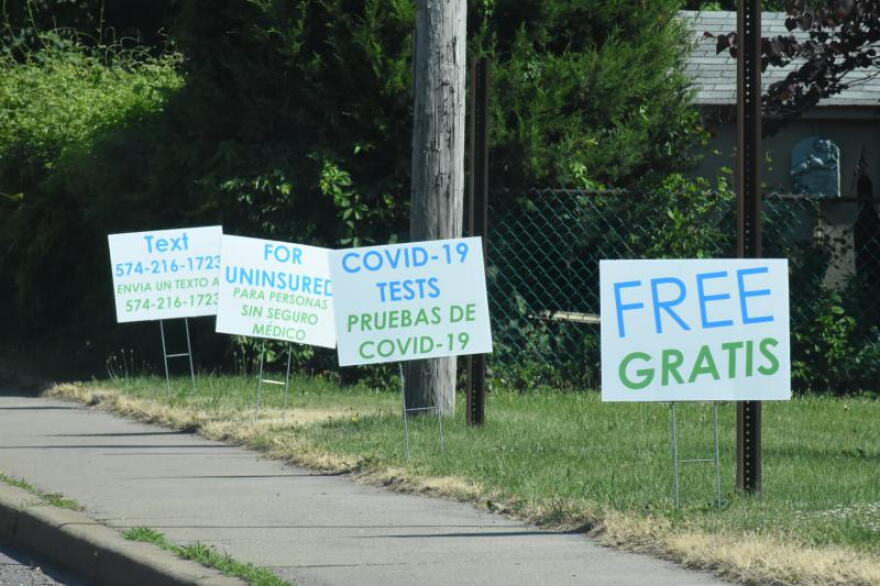 Signs in English and Spanish near a COVID-19 testing site in Goshen, Indiana.