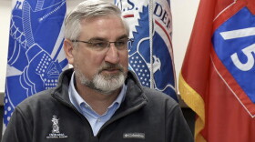 Gov. Eric Holcomb speaks during a Tuesday news conference at Camp Atterbury.