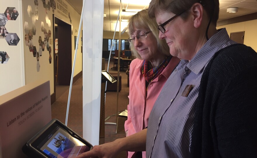 Meg Miner and Karen Schmidt look at touch screen.