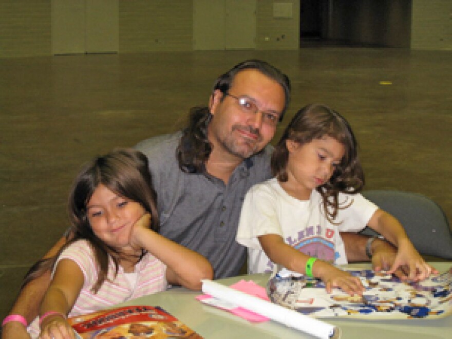 Richard Foreman of Beaumont and his two children at the Dallas Convention Center.