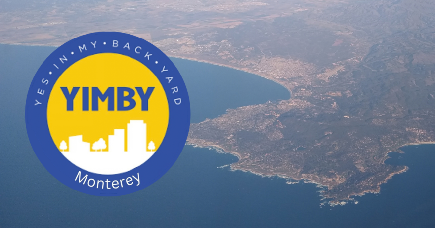 A logo with a blue ring and white text, and a yellow center with white buildings in silhouette and blue letters. Behind it is an aerial view of water with a landmass.