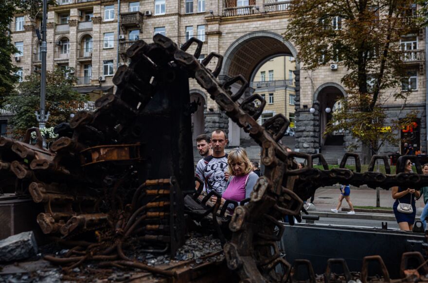 People look at destroyed Russian military equipment at Khreshchatyk street in Kyiv.