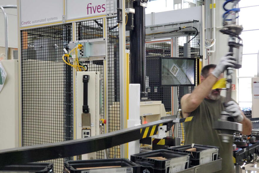 A worker assembles parts along the line at FCC Transmission plant in Tipton, Indiana.