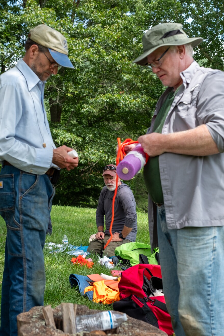 The trainees work to apply a tourniquet to a pool noodle as part of a CERT exercise.