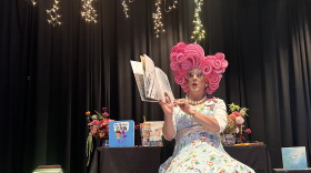 Miss Shirley reading at book at the drag queen story time in Gunnison.