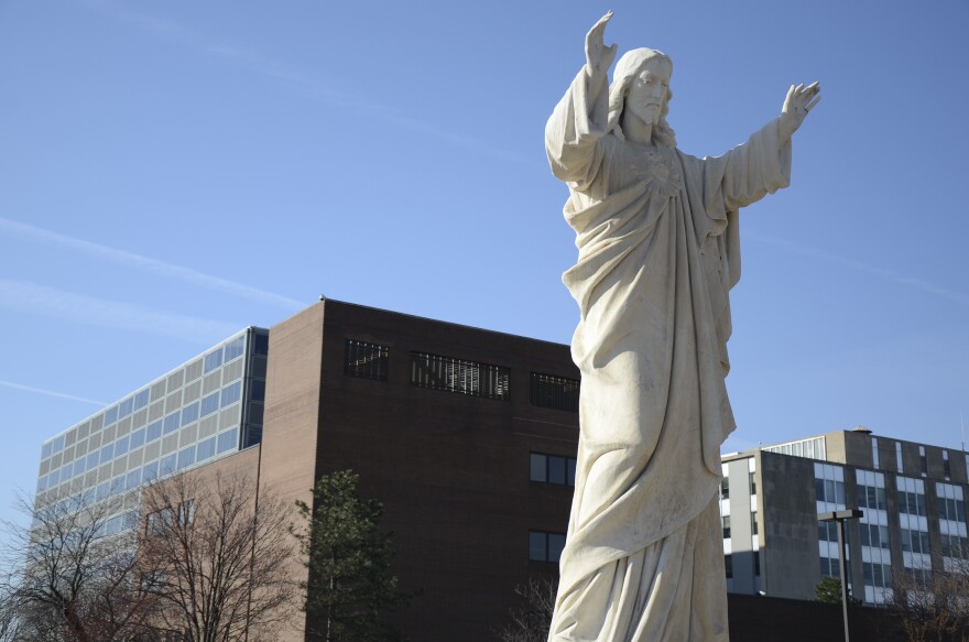 A statue of Jesus watches over Fort Wayne. Behind it: the offices of Fort Wayne Community Schools.