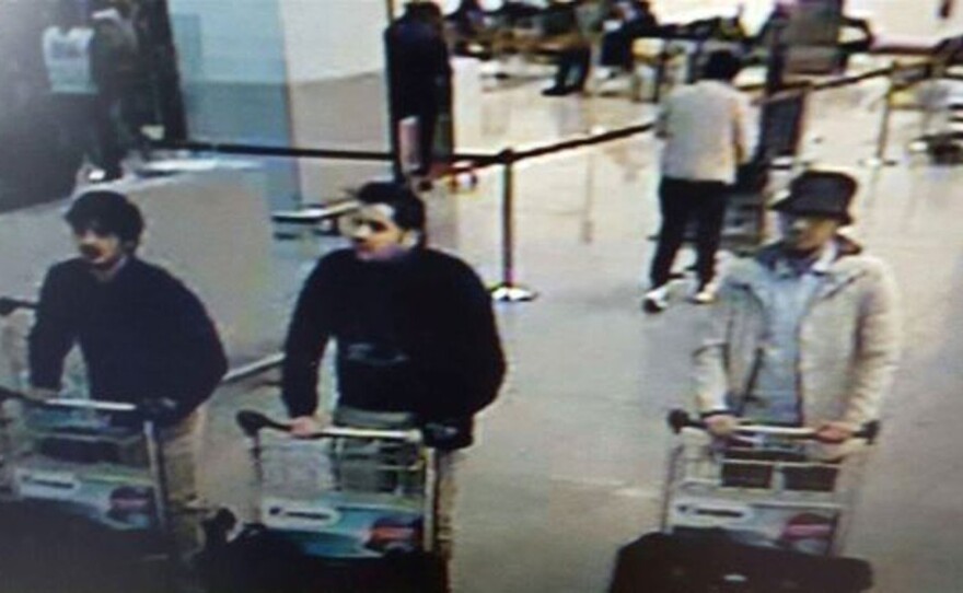 This image, provided by the Belgian Federal Police in Brussels, shows Ibrahim El Bakraoui (center), an unidentified attacker (left) and a wanted suspect (right) whose whereabouts are currently unknown.