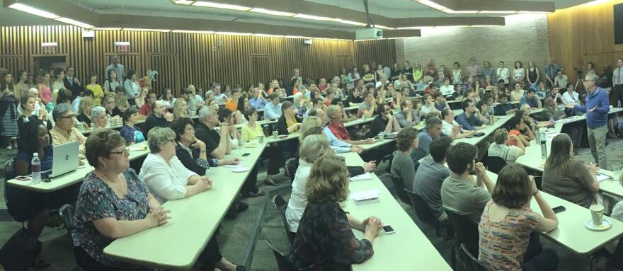 At a community meeting, Antioch College President, Mark Roosevelt annouces the receipt of several large funding grants, and his decision to leave the college after his contract expires.