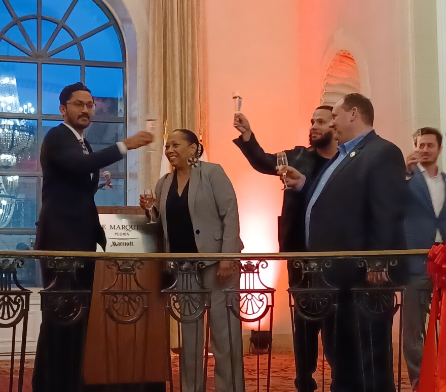 Bhavin Patel, CEO of Shreem Capital and new owner of the Marriott-Pere Marquette Hotel is pictured speaking during a ribbon cutting celebrating the building's new ownership on Nov. 13. At right is Discover Peoria CEO JD Dalfonso and Dalfonso's son.