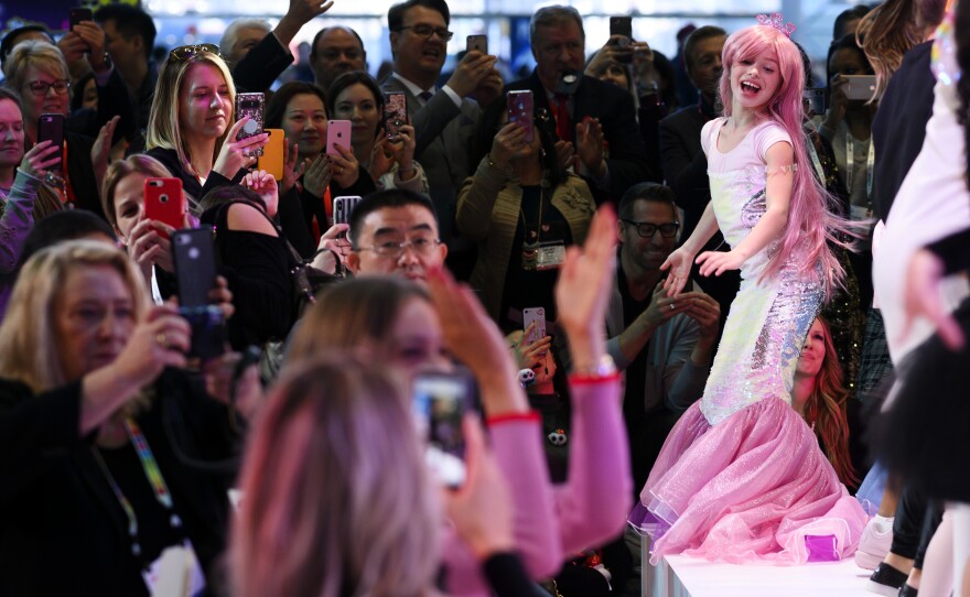 A girl dressed as a mermaid worked the runway at a fashion show at the toy show.