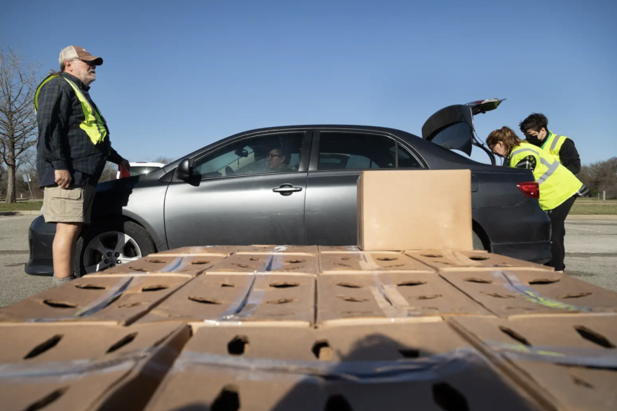  From left: Ross Fields, Susan Morgan and Baron Reedy work to load boxes into the trunk of a vehicle at the Onion Creek Soccer Complex in Austin. The Central Texas Food Bank operated 56 drive-thru events across the state in March.