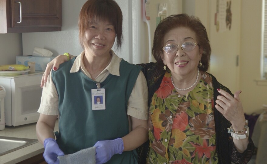 Belle with a housekeeper provided by On Lok, a San Francisco program that makes it possible for aging seniors with chronic illnesses or disabilities to remain in their own homes.