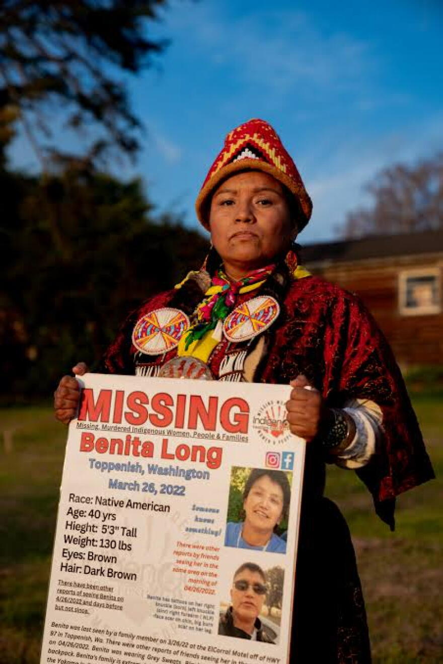 Indigenous woman holding missing woman poster