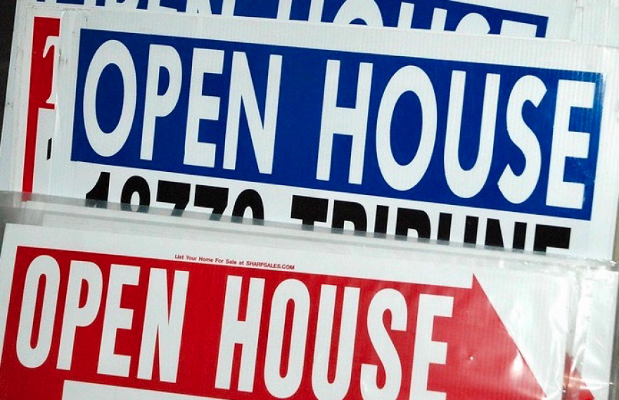 A close up image of several open house signs.