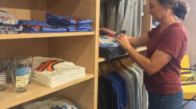 Owner Audrey Falk looks through Thunder t-shirts at Shop Good in Oklahoma City.