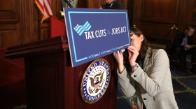 A staffer for Speaker of the House Paul Ryan prepares signage as the House votes on the Tax Cuts and Jobs Act at the U.S. Capitol on Nov. 16, 2017 in Washington, D.C. (Chip Somodevilla/Getty Images)