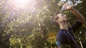 A man pouring water onto his fac