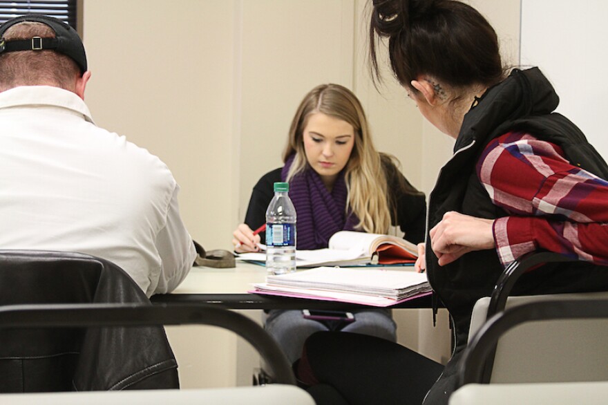 Tulsa Community College freshman Zoey Radcliffe, center, looks at her notes while preparing for a final in her remedial math course. Thousands of Oklahomans take remedial college courses each year to relearn content they should have learned in high school