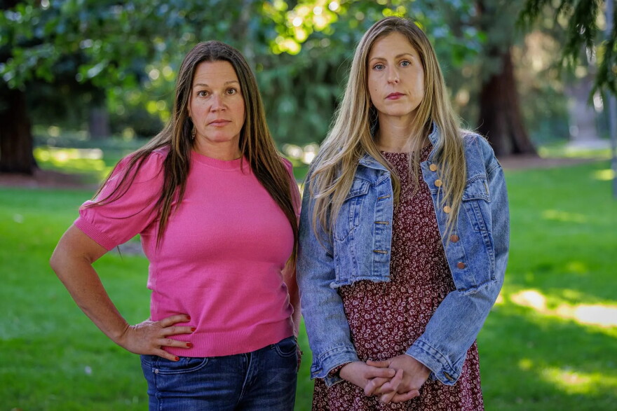 Michelle Caswell, left, and Megan McCarty pose at Riverside Park in Grants Pass, Oregon. Caswell, McCarty and other former residents of 5Rock Ranch have urged the nonprofit’s leadership to shut down the organization.