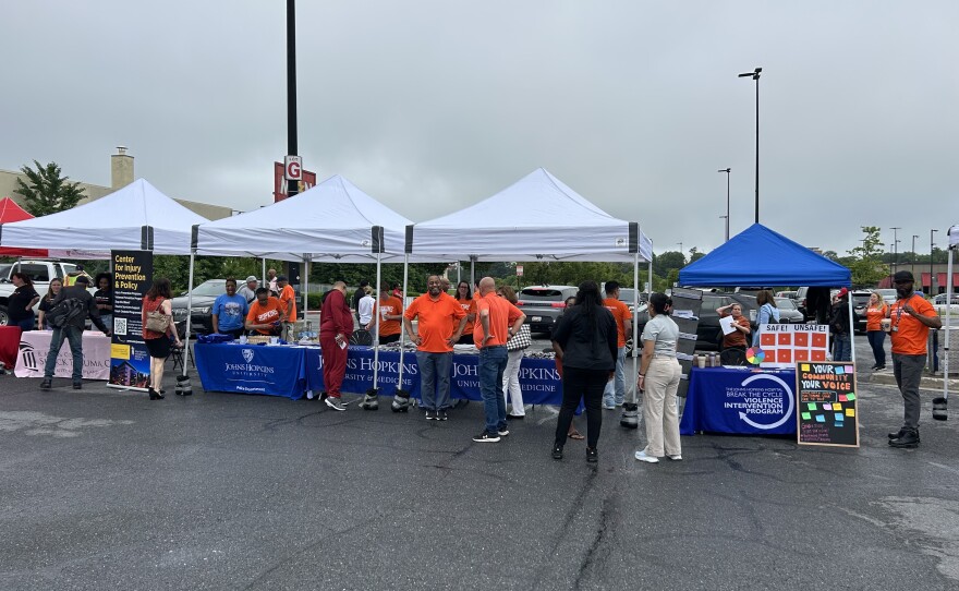 Community partners working to address gun violence in Baltimore City wear orange t-shirts at an event marking Gun Violence Awareness. Photo by Wambui Kamau/WYPR.