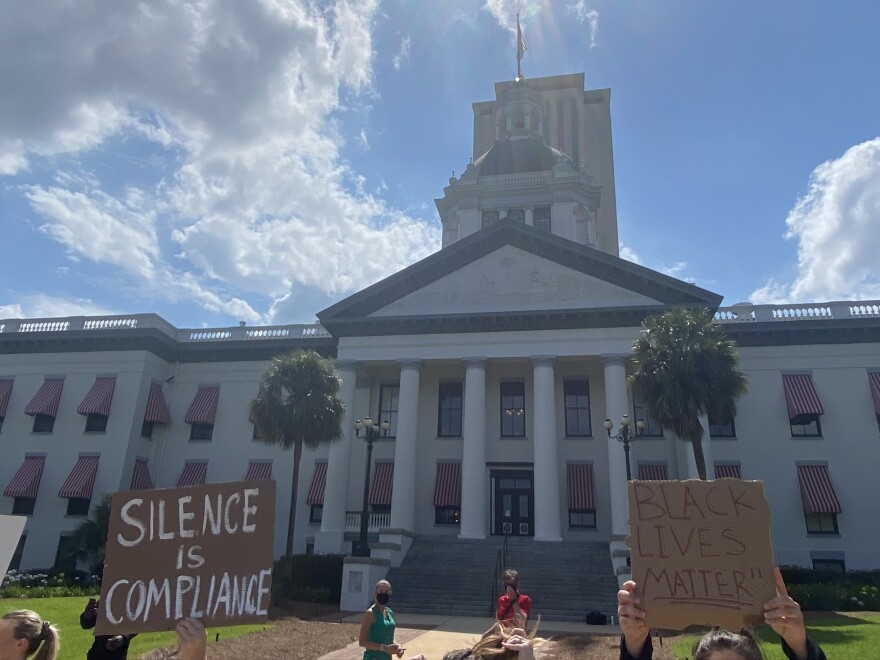 Protesters holding up signs in front of the capitol building on Jun. 1, 2020 in Tallahassee, Fla.